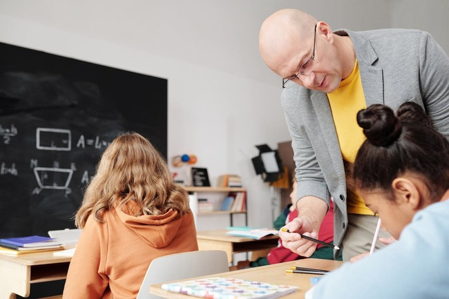 Profesor cu elevi in sala de clasa